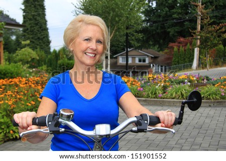 Attractive senior lady on a bicycle.