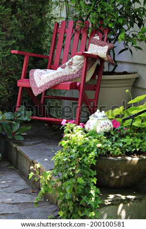 Colorful rocking chair in a cottage garden setting.