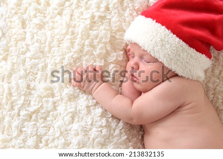 Christmas baby wearing a Santa hat