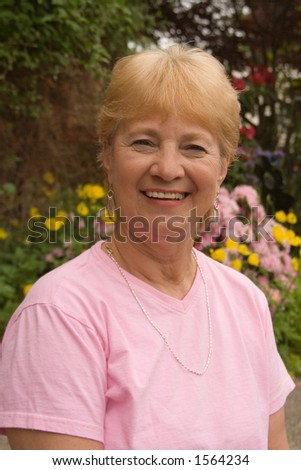 Happy grandma outside in her garden.