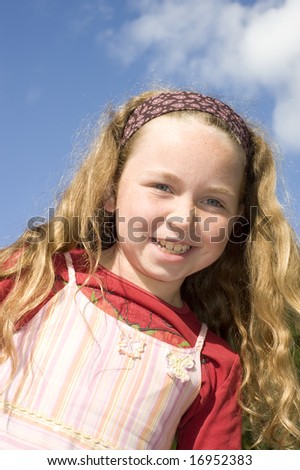 smiling girl with freckles looking into camera