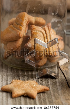 Homemade sugar cookies with metal cookie cutters on old wooden table