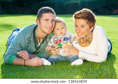 Happy family lying down in the garden