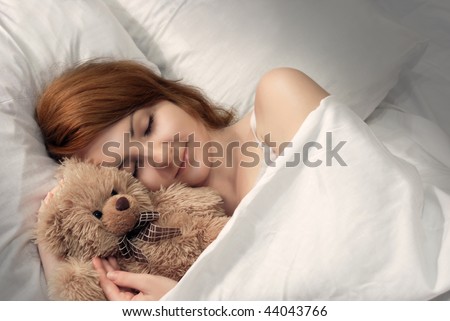 Beautiful woman sleeping with the toy bear