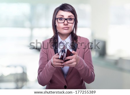 Beautiful business woman with empty purse. Business decisions. Office workers. Bemused girl in glasses. Beautiful light background.