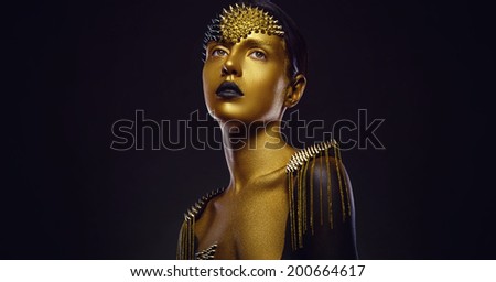 Beautiful young woman with gold makeup