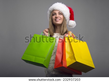 Beautiful young girl with shopping. New Year\'s Eve. Christmas discounts. Holiday Shopping