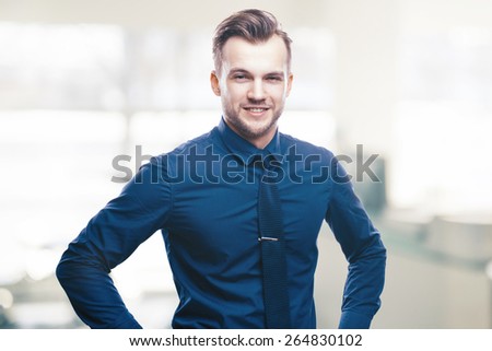 Handsome stylish young man in shirt looking at the camera. Office worker. Business decisions