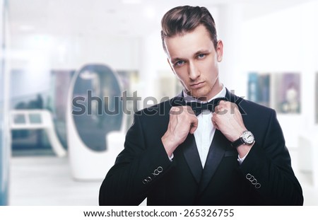 Handsome young man in a tuxedo looking at the camera. Fashionable Clothing. Clothing for the festive evening
