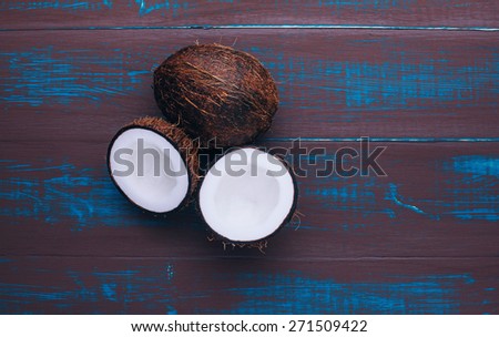 Open coconut on the board. Exotic fruits. Wooden board rustic