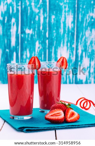 Red refreshing strawberry smoothie. Fruit cocktail. Delicious vitamin smoothies. Healthy food. Fruit diet. Wooden board rustic