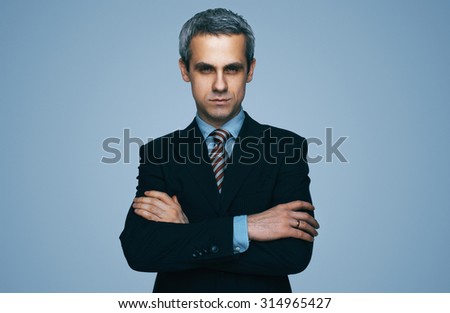 Male businessman in a business suit. Trendy business clothes. Office worker. Brutal man looking into the camera. Looking at the camera. Business decisions