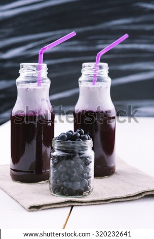 Refreshing blueberry smoothie. Fruit cocktail. Delicious vitamin smoothies. Healthy food. Fruit diet. Wooden board rustic
