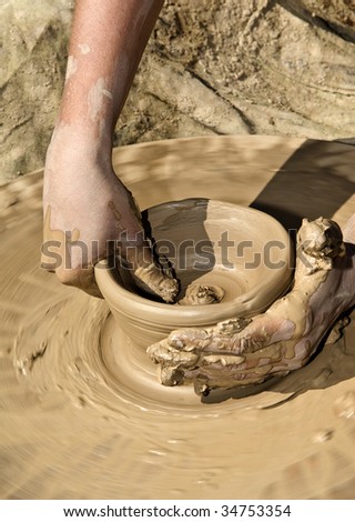 potter's wheel and hands of the potter