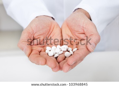 Close-up of doctor holding a pills in the hands