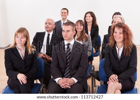 Portrait Of A Business Men And Women Attending A Seminar
