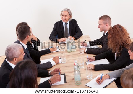 Portrait Of A Serious Business Men And Women Attending A Seminar