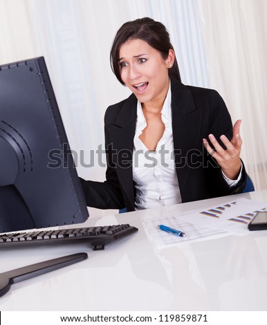 Studio shot of a frustrated businesswoman looking at her computer screen in dismay