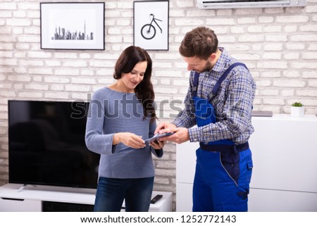 Similar – Image, Stock Photo Plumber signs a contract for the services in the kitchen