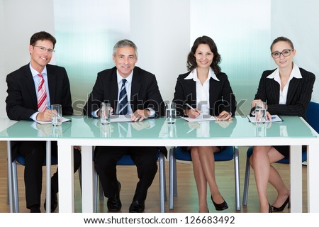 Panel of corporate personnel officers sitting at a table