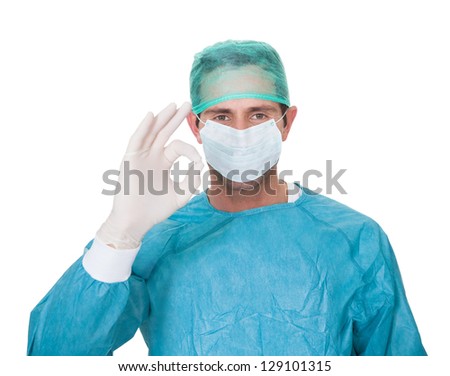 Male surgeon in scrubs uniform making Okay gesture. Isolated on white