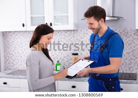 Image, Stock Photo Plumber signs a contract for the services in the kitchen