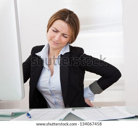 Business Woman With Back Pain Holding Her Aching Hip