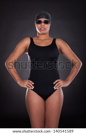 Portrait Of Young Female Swimmer Isolated Over Black Background
