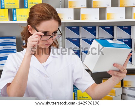 Female Pharmacist Chemist Working In The Pharmacy