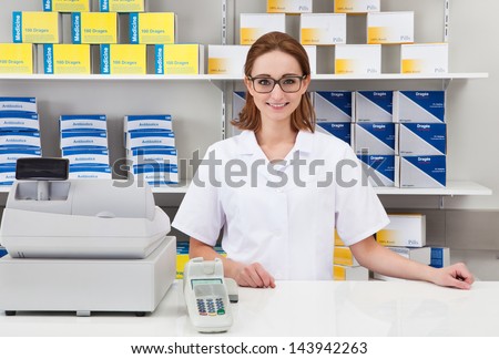 Portrait Of Happy Female Pharmacist In Pharmacy