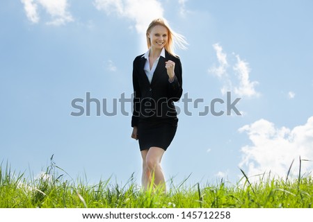 Successful Excited Business Woman Standing In Grass