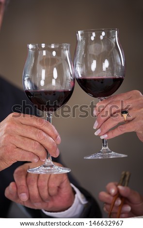 Happy Mature Couple Toasting Wine In A Elegant Restaurant