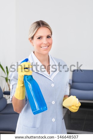 Young Happy Maid Holding Bottle And Sponge