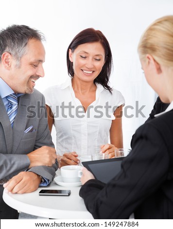 Group Of Happy Multiracial Businesspeople Discussing Together In Office