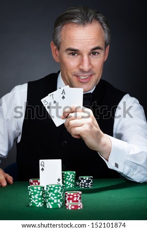 Close-up of a croupier holding aces of spade and heart