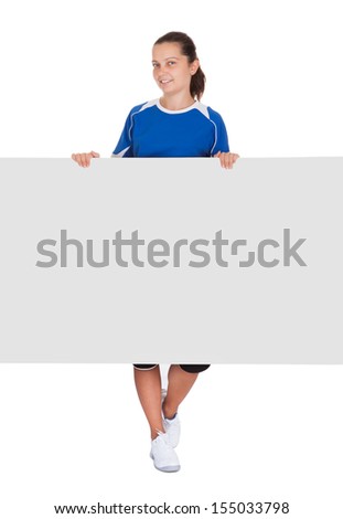 Happy young woman holding blank placard on white background