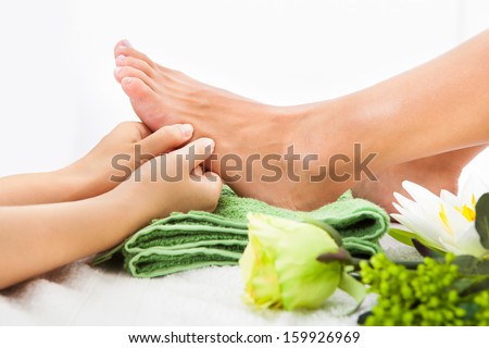 Close-up Of Woman Feet Receiving Foot Massage In Spa