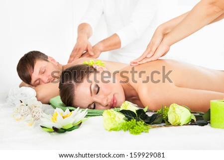 Attractive Couple Lying Side By Side Enjoying Spa Treatment