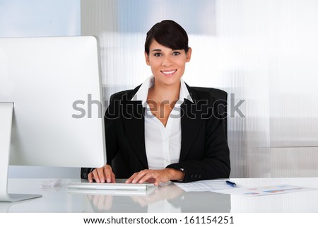 Happy Business Woman Working On Computer In The Office