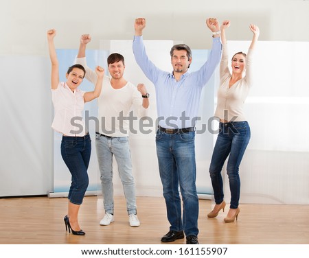 Happy Group Of People Raising Arm Together