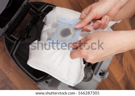 Person\'s Hand Removing Dust Bag From Vacuum Cleaner