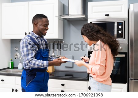 Similar – Image, Stock Photo Plumber signs a contract for the services in the kitchen