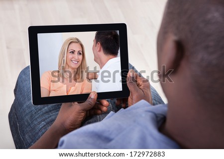 Close-up Of African Man Watching Video On Digital Tablet