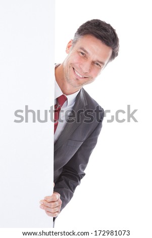Happy Businessman Holding White Board Over White Background