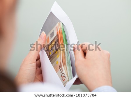 Close-up Of Person Checking Out Envelope With Cash
