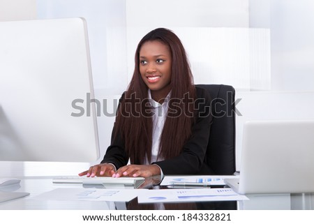 Portrait of confident businesswoman working at desk in office