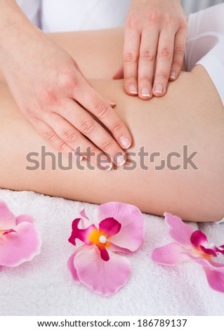 Close-up Of A Woman Getting Thigh Massage Treatment At Spa