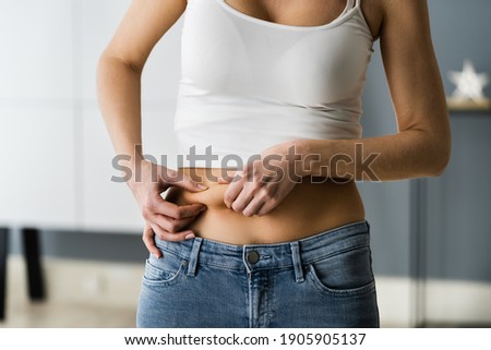 Stomach Fat Liposuction And Diet. Stomach Skin Pinch Photo stock © 