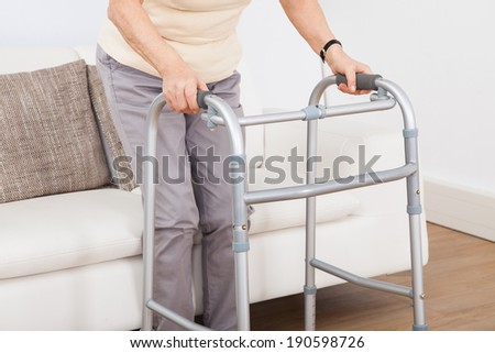 Closeup of senior woman using walking frame at nursing home
