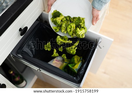 Throwing Away Leftover Food In Trash Or Garbage Dustbin Stockfoto © 